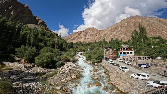 Beautiful mountain river flowing through Turtuk village in Ladakh, India - crystal-clear water, green valley, and peaceful Himalayan scenery.