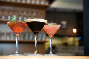 Three Elegant Cocktails in Martini Glasses