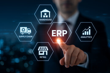 Businessman touching central erp text in a futuristic glowing hexagonal screen surrounded by icons for warehouse, supply chain, retail, and analytics representing enterprise resource planning