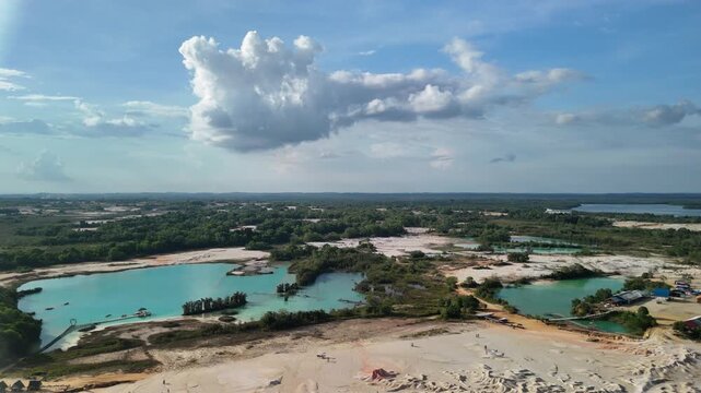 bintan islands blue lagoon also known as danau biru features striking turquoise waters surrounded by white sand hills creating a stunning contrast and serene tropical atmosphere