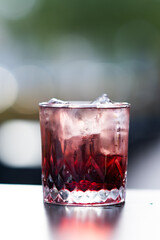 Red cocktail with garnish in glass