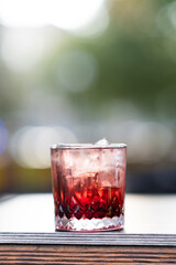 Red cocktail with garnish in glass