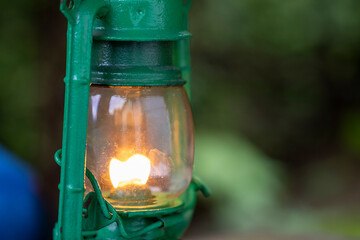 Vintage green kerosene lamp with warm flame