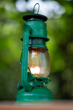 Green kerosene lantern glowing softly outdoors