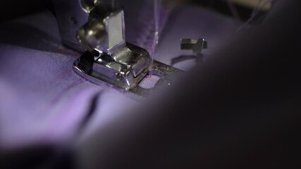 Close-up sewing machine demonstration of stitching techniques on purple fabric using a presser foot