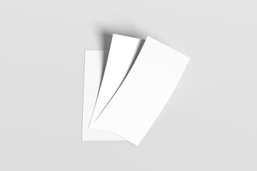 Minimalistic composition featuring three blank white sheets of paper arranged on a light gray surface. Perfect for mockups, stationery presentations, or design templates.