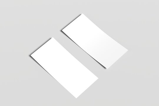 Minimalist composition with two blank white sheets of paper placed side by side on a light gray surface. Perfect for mockups, print design presentations, or background templates.