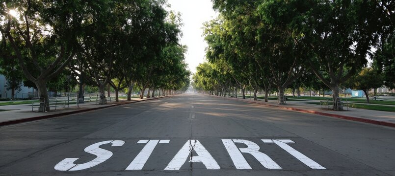 Empty Urban Parkway with Large START Text and Symmetrical Trees