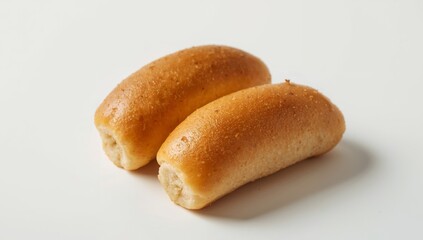 Two golden brown rolls sit side by side on a clean, bright white surface.