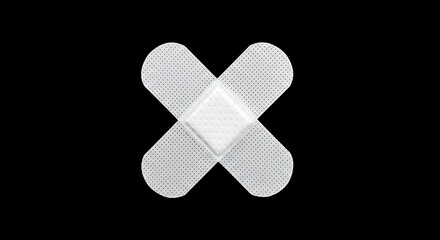 Two white adhesive bandages crossed on black background medical first