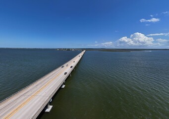 Aerial View Of Washington Baum Bridge Over Calm Water of Roanoke Sound Connecting Roanoke Island to Nags Head on the Outer Banks. Bright blue sky, tranquil water, urban-seaside scene.