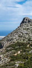 Rocky mountain peak with cross overlooking coastal landscape, Crete