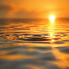 Brilliant orange sunset reflects across water surface showing circular ripple from drop impact