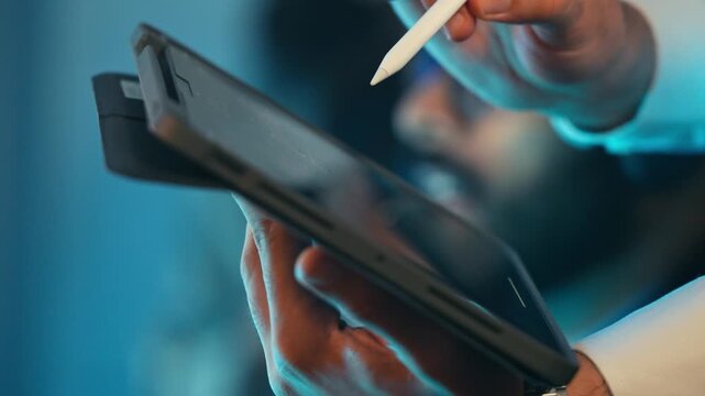 Indian male customer service agent or call center wearing a headset and glasses discussing with client at the office. Professional remote work, technical support. Telecommuting, telemarketing