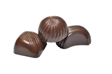 Chocolate candies with fillings of different shapes lie on a PNG background.