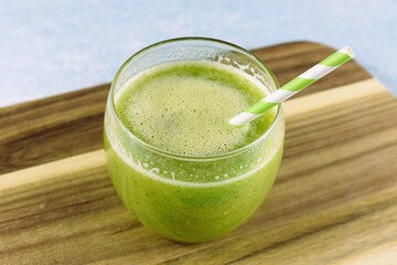 Single glass of smoothie made of green vegetables and fruits. 