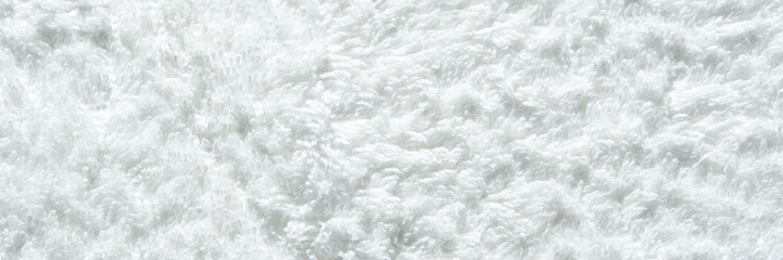 Close-up of soft white furry texture with fluffy pattern for background or design inspiration.