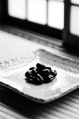 Black beans on ceramic plate in minimalist black and white japanese setting