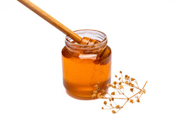 Honey jar and  honey dipper  on white background