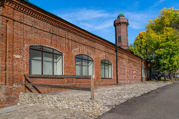 Historic 1890 fire station in Ulyanovsk with brick facade and wooden tower. Arched windows and cobblestone enhance the historic atmosphere.