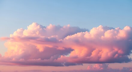 A view of pink and white cumulus clouds floating in a light blue sky during a colorful sunset