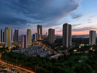 Obraz premium night cityscape view, calm night with illuminated skyline, silent city lights under evening sky