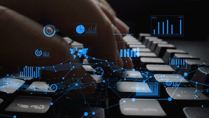Focus on hands typing on keyboard with overlay of digital data visualizations, representing...