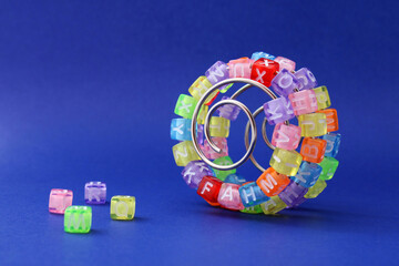 Colorful cubes with letters on a metal spiral, learning curve