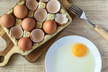 Fresh eggs and raw egg on a kitchen counter