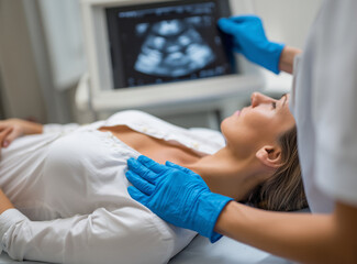 Woman undergoing ultrasound examination in a clinic with medical staff present Generative AI