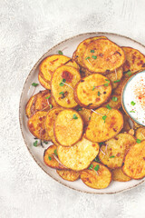 Crispy potato slices, with parmesan cheese and spices, fried in the oven, homemade, no people,