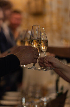 Clinking champagne glasses with bokeh background