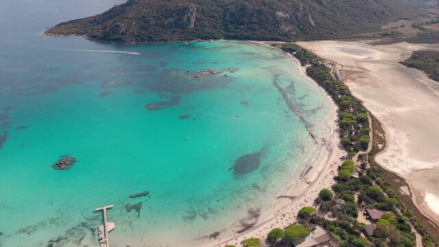 sunny corsican scenic panorama, serene turquoise waters with lush pinecovered headlands visible. France