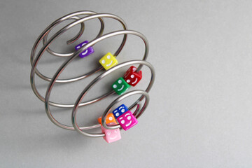 Colorful cubes with happy faces in a metal spiral