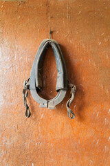 A Vintage Horse Harness Displayed on a Rustic Wooden Background