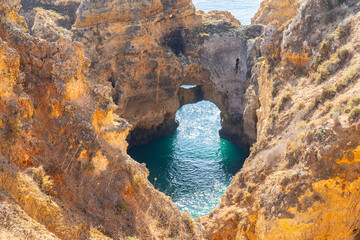 Ponta da Piedade near Lagos in Algarve, Portugal. Tourist boats and cliff rocks in the Atlantic Ocean at Ponta da Piedade, Algarve region, Portugal.