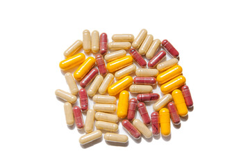 Assorted capsules on white background with yellow, red, and beige colors