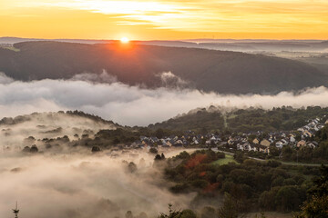 Sunrise over Rhine River near Bad Salzig in Germany with mist covering the hills and valley