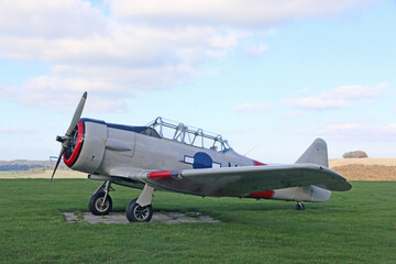 Light airplane standing on a grass runway	