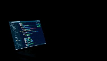 Bright Coding Screen Illuminates Dark Room During Late-Night Programming Session