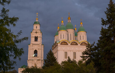 View of the Astrakhan Kremlin with the Assumption Cathedral and the bell tower late in the evening on a cloudy day. Astrakhan, Russia