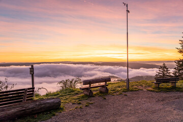 Sunrise casts a warm glow over the Rhine River near Bad Salzig in Germany with misty clouds below
