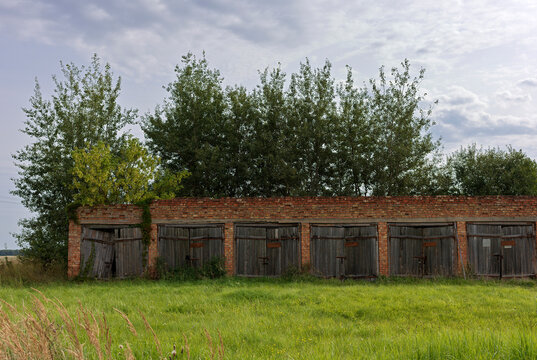 Red brick garages with wooden doors