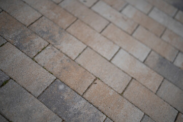 Brick surface shot at an angle with selective focus, concept of texture and architectural detail.