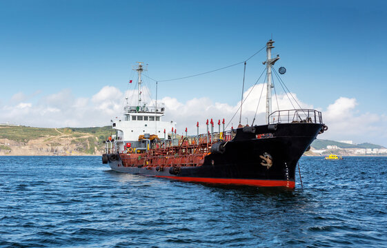 Ship, industrial bulk carrier tanker anchored in  sea.