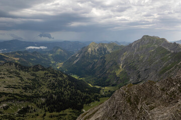 Mountain landscape view from Nebelhorn in the German Alps showcasing lush valleys and dramatic skies