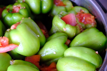 Homemade stuffed peppers with meat, close-up. Stuffed peppers in a steel pot on the stove, ready to cook. Traditional Turkish food. Casserole dish. Healthy eating.