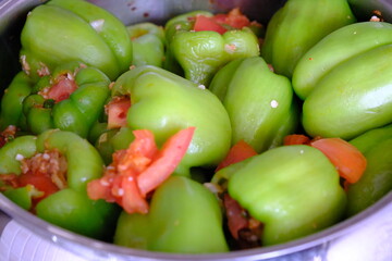 Homemade stuffed peppers with meat, close-up. Stuffed peppers in a steel pot on the stove, ready to cook. Traditional Turkish food. Casserole dish. Healthy eating.