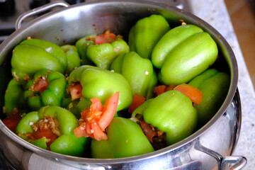 Homemade stuffed peppers with meat, close-up. Stuffed peppers in a steel pot on the stove, ready to cook. Traditional Turkish food. Casserole dish. Healthy eating.