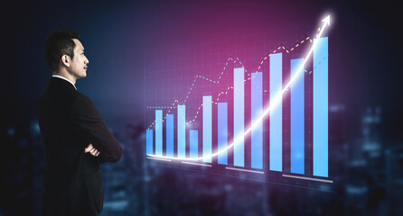 A dedicated businessman evaluates the upward trend in financial data through graphs, representing...